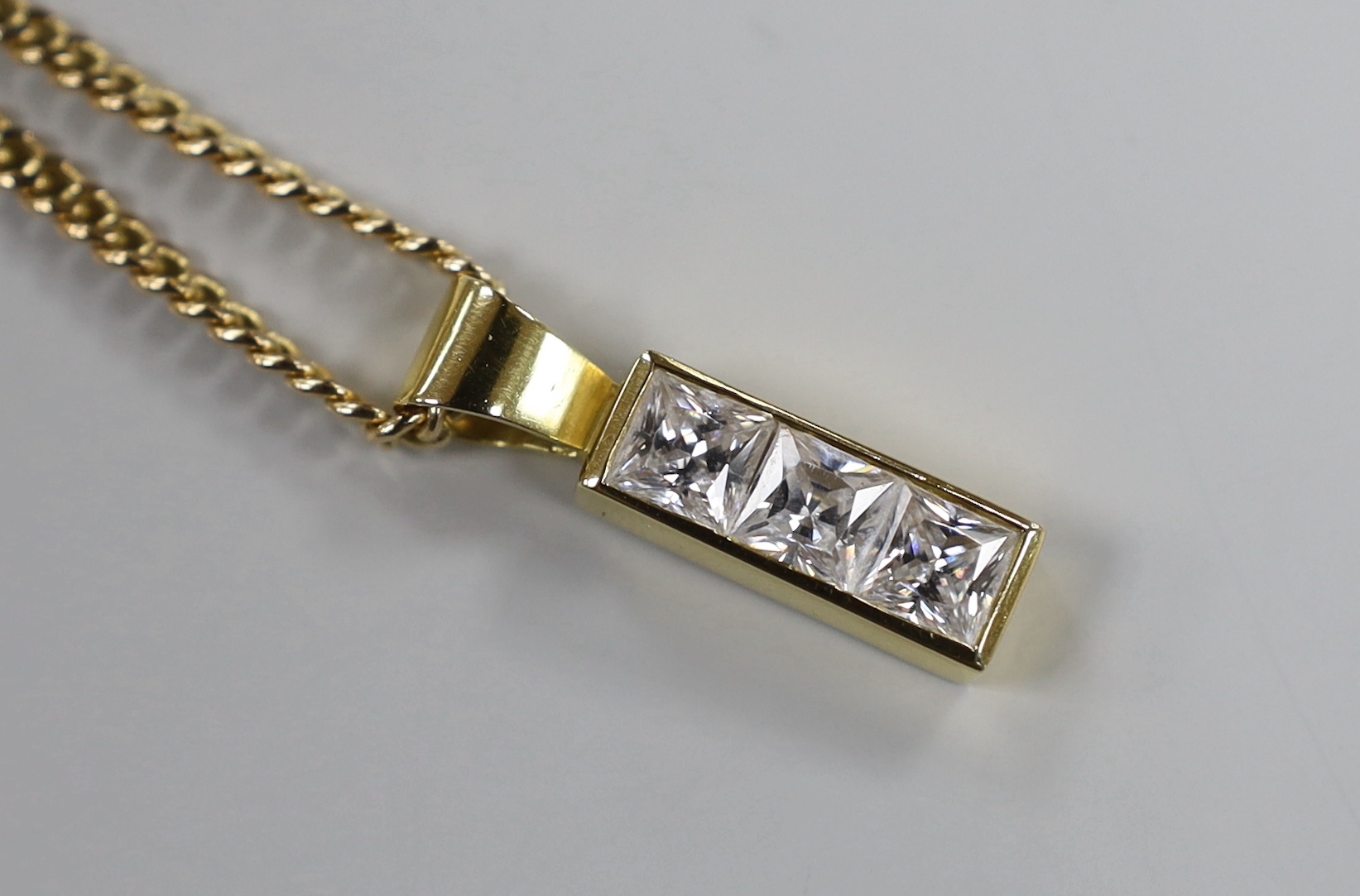 A modern 18ct gold and six stone cubic zirconia set half hoop dress ring, size P, gross weight 12.6 grams and a similar pendant, gross 4.3 grams, on a 9ct gold chain, 11 grams.